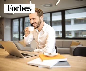 professional man drinking coffee by his new trade-in laptop